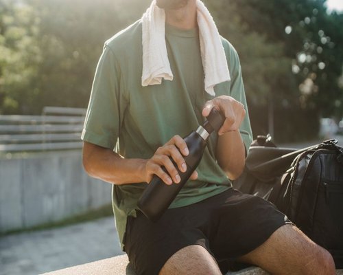 Person relaxing and hydrating after a long commute